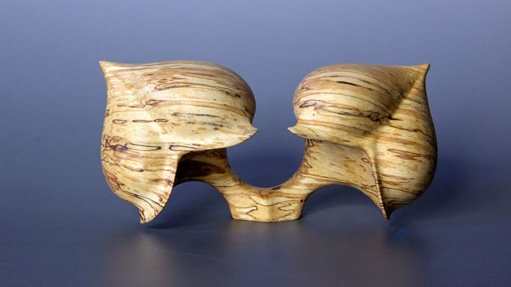 Front view of the "Couple Seed" sculpture in spalted birch composed of two heart-shaped elements that cannot be separated - Original creation by Coralie Saramago